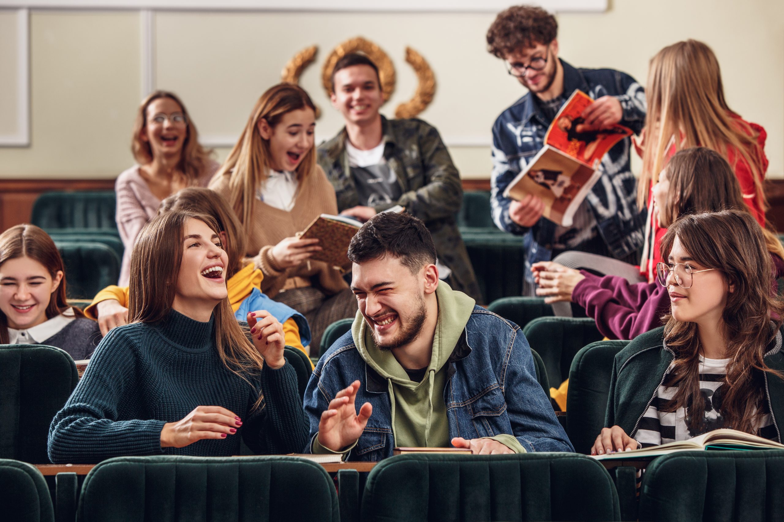 The group of cheerful happy students sitting in a lecture hall before lesson Cheerful Students
