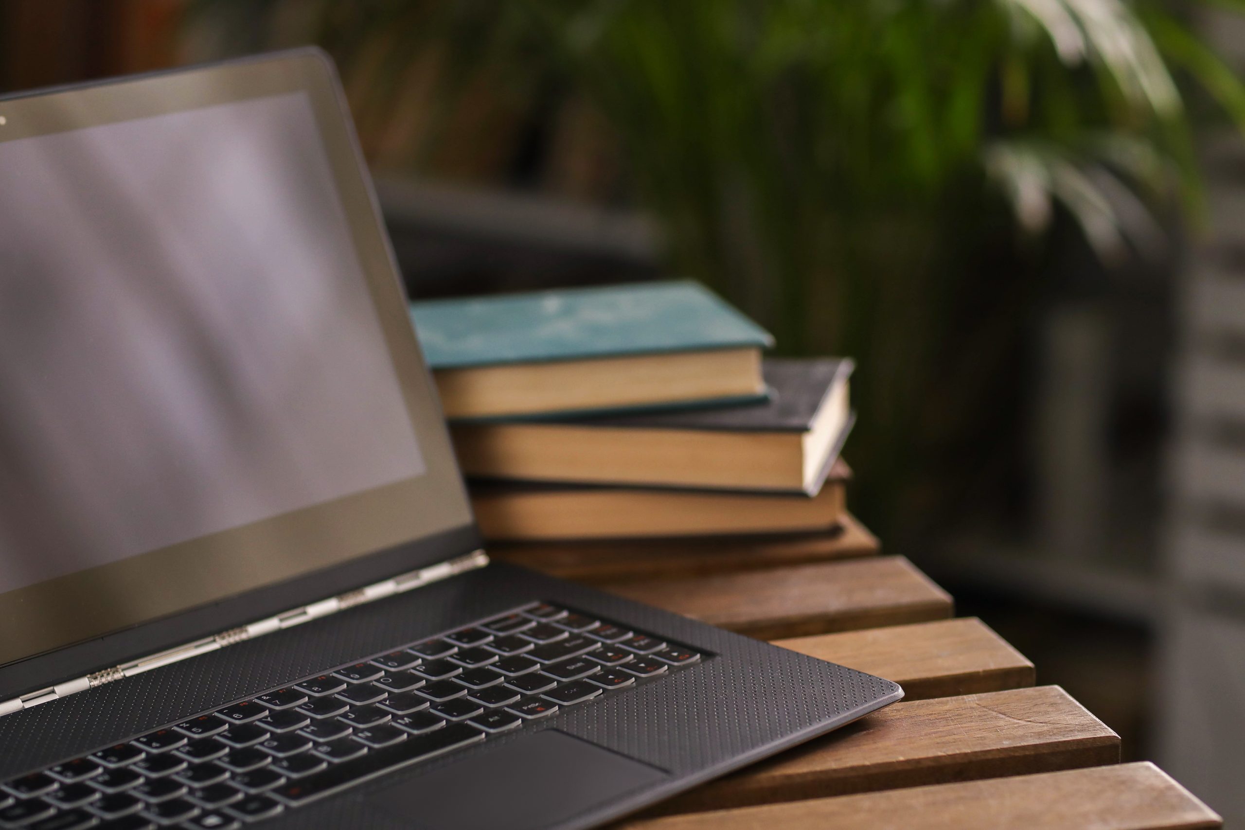 Laptop with books in the background