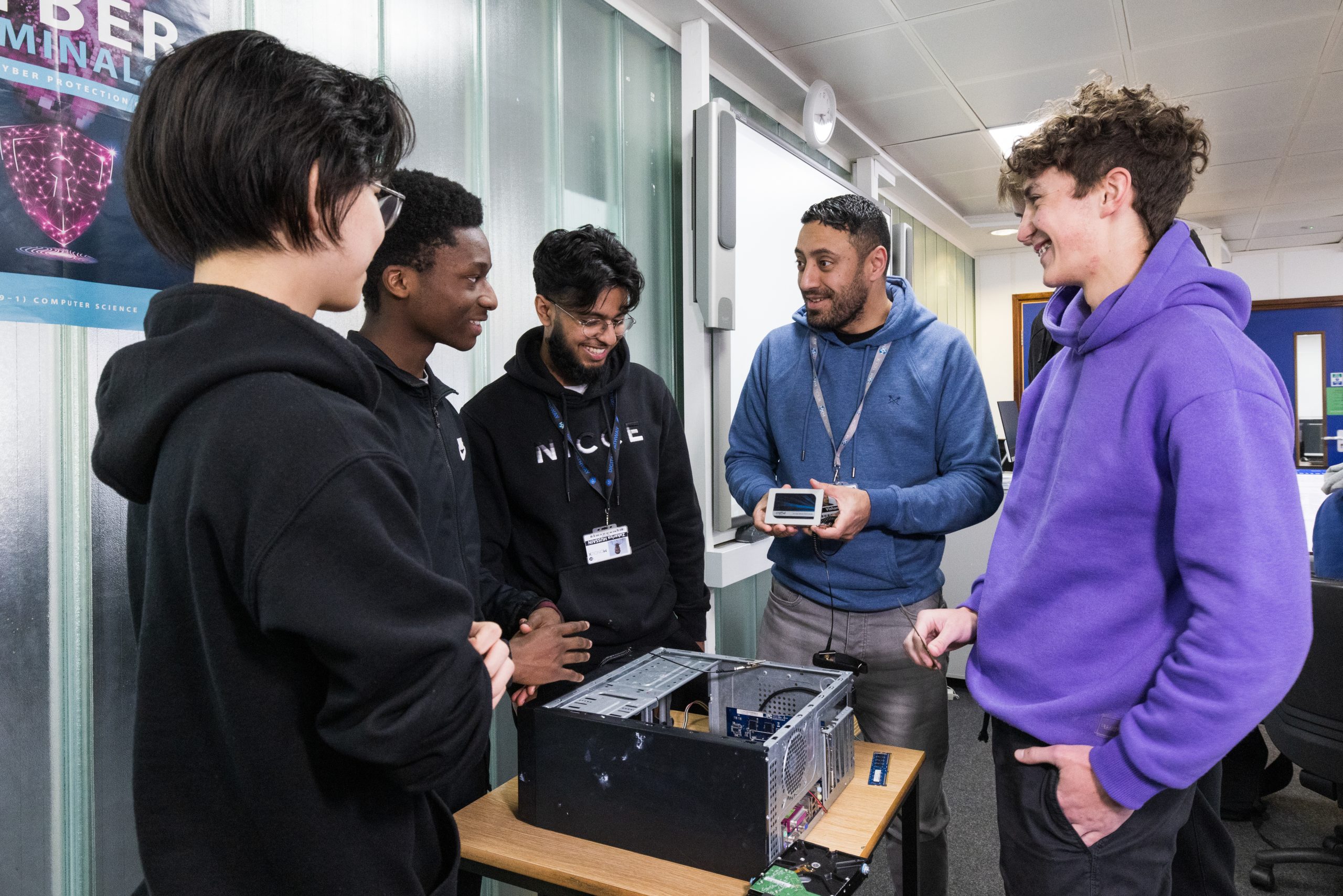 Teacher with four students showing a PC